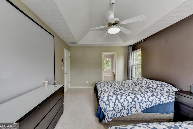 3668 Burel Mill Dr, Buford, GA 30519 - bedroom featuring a raised ceiling, light colored carpet, baseboards, ceiling fan, and connected bathroom