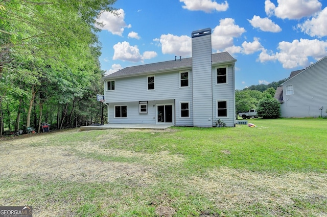 3668 Burel Mill Dr, Buford, GA 30519 - back of house with a chimney, a lawn, and a patio