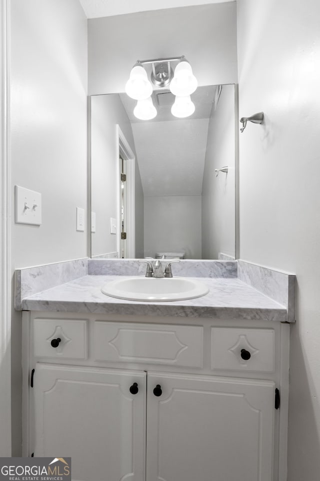 bathroom featuring vanity and a chandelier