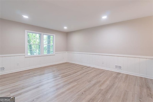 4171 Whispering Forest Ct SW, Lilburn, GA 30047 - unfurnished room with wood finished floors, a wainscoted wall, and recessed lighting