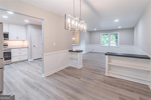 4171 Whispering Forest Ct SW, Lilburn, GA 30047 - unfurnished dining area featuring a wainscoted wall, light wood-style floors, a chandelier, and recessed lighting
