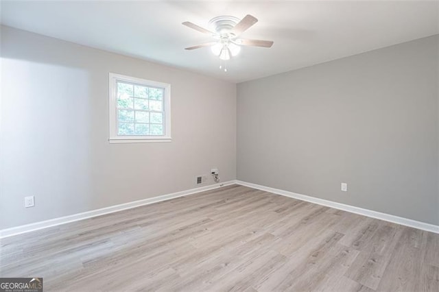 4171 Whispering Forest Ct SW, Lilburn, GA 30047 - empty room featuring light wood-type flooring, a ceiling fan, and baseboards