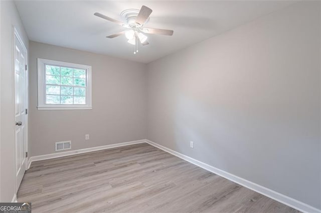 4171 Whispering Forest Ct SW, Lilburn, GA 30047 - spare room featuring light wood-type flooring, baseboards, and a ceiling fan