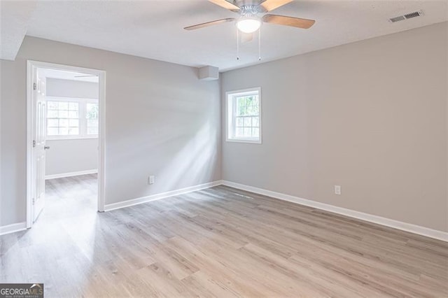 4171 Whispering Forest Ct SW, Lilburn, GA 30047 - empty room with plenty of natural light, light wood-type flooring, ceiling fan, and baseboards