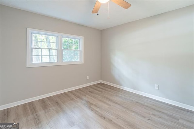 4171 Whispering Forest Ct SW, Lilburn, GA 30047 - spare room featuring baseboards, light wood-style flooring, and ceiling fan