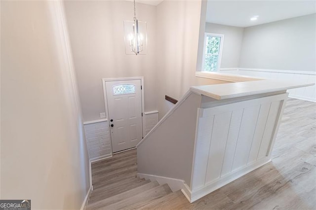 4171 Whispering Forest Ct SW, Lilburn, GA 30047 - stairway with a chandelier and wood finished floors