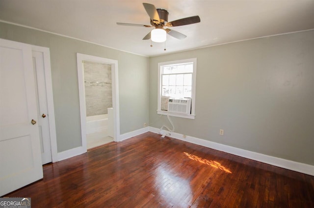 unfurnished bedroom featuring wood finished floors, cooling unit, baseboards, connected bathroom, and ceiling fan