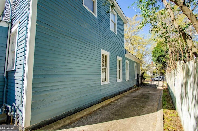 view of side of property featuring fence