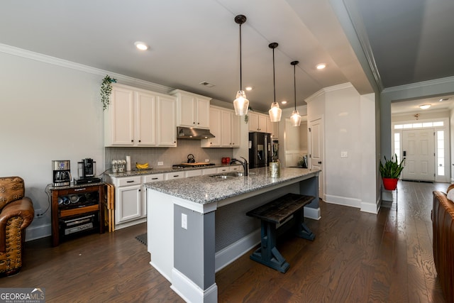 4832 Stone Way Path, Buford, GA 30519 - kitchen with under cabinet range hood, black refrigerator with ice dispenser, a sink, stainless steel gas stovetop, and ornamental molding