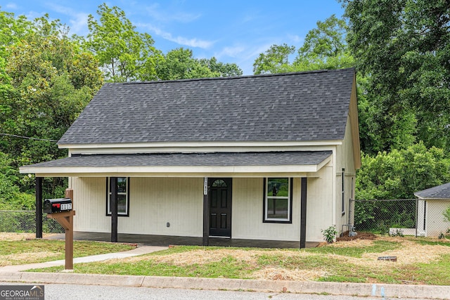 view of front of house featuring a shingled roof and a porch