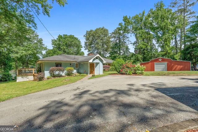 312 Flat Shoals Church Rd, Stockbridge, GA 30281 - view of front of house with an outdoor structure, a front yard, a detached garage, and a chimney