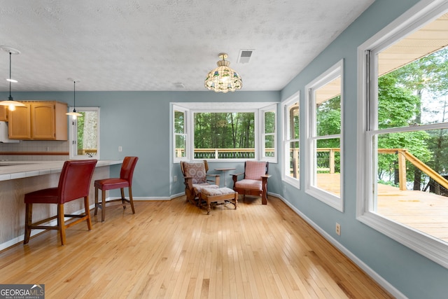 312 Flat Shoals Church Rd, Stockbridge, GA 30281 - interior space featuring tile countertops, baseboards, light wood-style floors, hanging light fixtures, and decorative backsplash