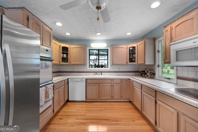 312 Flat Shoals Church Rd, Stockbridge, GA 30281 - kitchen featuring white appliances, light wood finished floors, backsplash, recessed lighting, and a sink