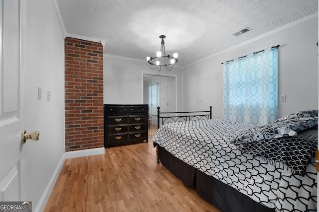 312 Flat Shoals Church Rd, Stockbridge, GA 30281 - bedroom featuring light wood finished floors, a chandelier, ornamental molding, baseboards, and a textured ceiling