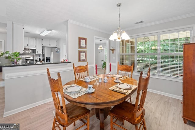 1152 Strath Clyde Way, Mcdonough, GA 30253 - dining room featuring light wood-type flooring, a chandelier, ornamental molding, and baseboards