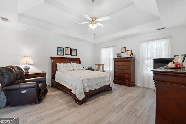 1152 Strath Clyde Way, Mcdonough, GA 30253 - bedroom featuring a tray ceiling, multiple windows, light wood-type flooring, a ceiling fan, and ornamental molding