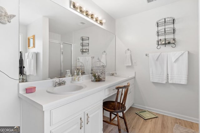 1152 Strath Clyde Way, Mcdonough, GA 30253 - full bathroom featuring wood finished floors, a stall shower, double vanity, and baseboards