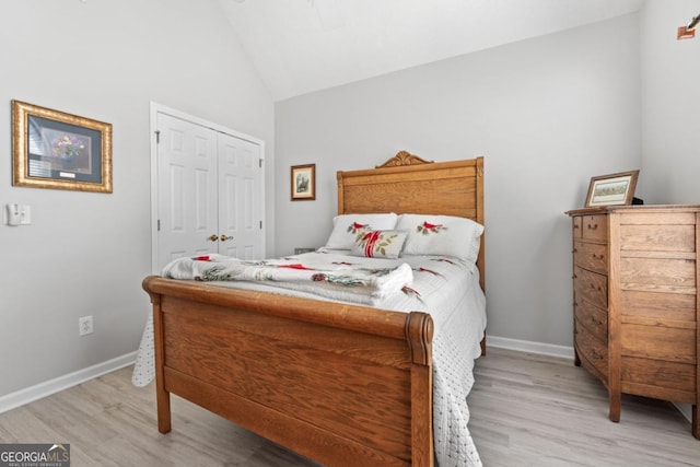 1152 Strath Clyde Way, Mcdonough, GA 30253 - bedroom with light wood finished floors, vaulted ceiling, baseboards, and a closet