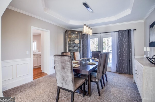 6450 Oak Valley Dr, Cumming, GA 30040 - carpeted dining area featuring a raised ceiling, ornamental molding, a wainscoted wall, and a chandelier