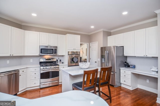 6450 Oak Valley Dr, Cumming, GA 30040 - kitchen with appliances with stainless steel finishes, light countertops, white cabinetry, ornamental molding, and recessed lighting