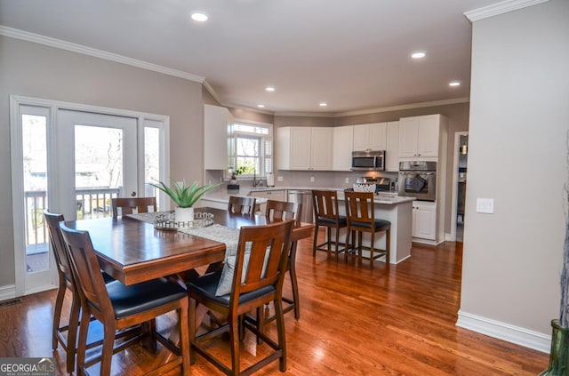 6450 Oak Valley Dr, Cumming, GA 30040 - dining space with ornamental molding, dark wood-style flooring, and recessed lighting