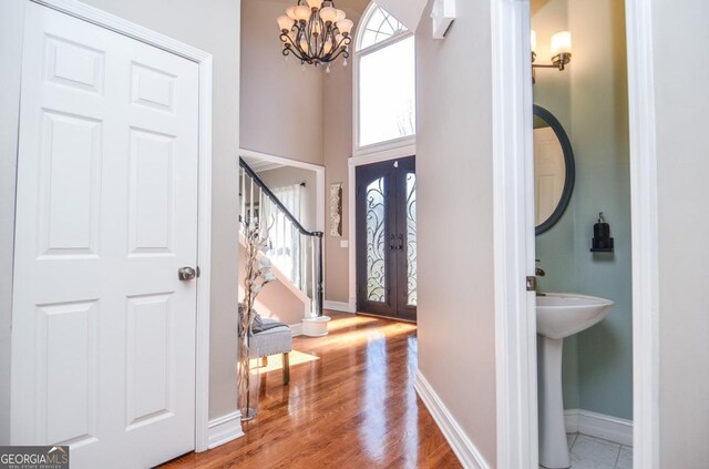 6450 Oak Valley Dr, Cumming, GA 30040 - foyer entrance with a chandelier, stairway, wood finished floors, and a high ceiling