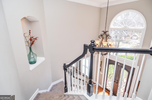 6450 Oak Valley Dr, Cumming, GA 30040 - staircase featuring a chandelier, arched walkways, ornamental molding, and french doors