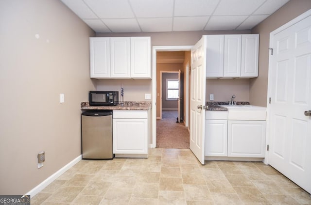 6450 Oak Valley Dr, Cumming, GA 30040 - kitchen with black microwave, white cabinetry, and a paneled ceiling