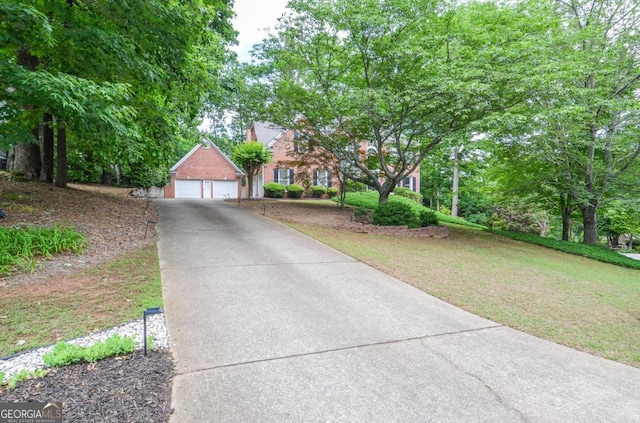 6450 Oak Valley Dr, Cumming, GA 30040 - view of front of home with a front yard, brick siding, and a detached garage
