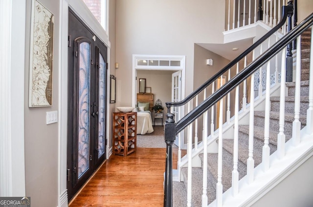 6450 Oak Valley Dr, Cumming, GA 30040 - foyer featuring a high ceiling, stairs, and wood finished floors