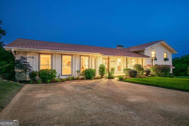 27 Graham Rd, Dallas, GA 30132 - tri-level home featuring metal roof, a chimney, a lawn, and board and batten siding