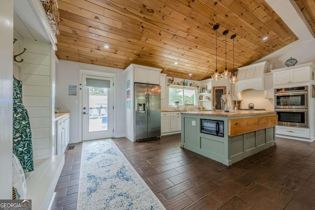 27 Graham Rd, Dallas, GA 30132 - kitchen with appliances with stainless steel finishes, wooden ceiling, vaulted ceiling, light countertops, and white cabinetry