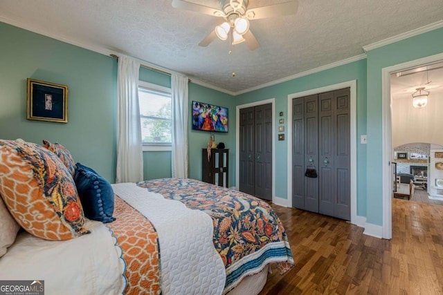 27 Graham Rd, Dallas, GA 30132 - bedroom with a textured ceiling, wood finished floors, two closets, ornamental molding, and baseboards
