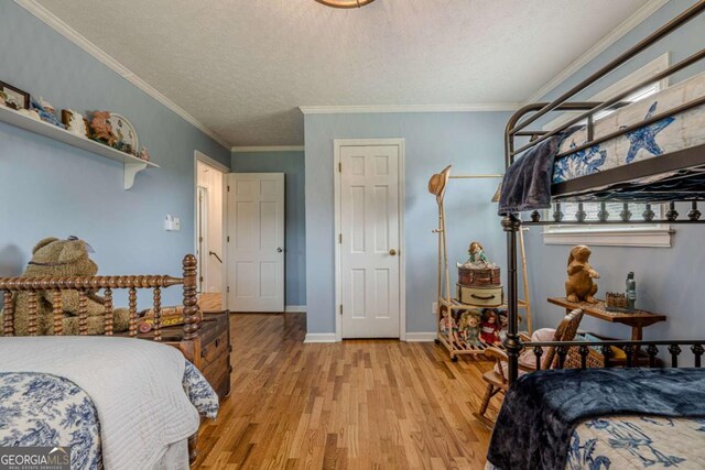 27 Graham Rd, Dallas, GA 30132 - bedroom featuring light wood finished floors, a textured ceiling, crown molding, and baseboards