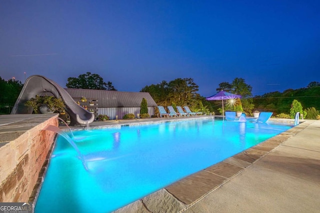 27 Graham Rd, Dallas, GA 30132 - pool at night featuring a water slide and a patio