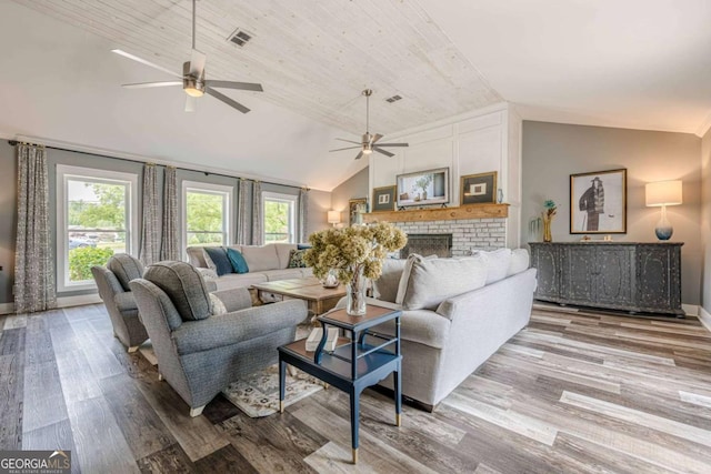 27 Graham Rd, Dallas, GA 30132 - living area featuring lofted ceiling, ceiling fan, wood finished floors, a brick fireplace, and baseboards