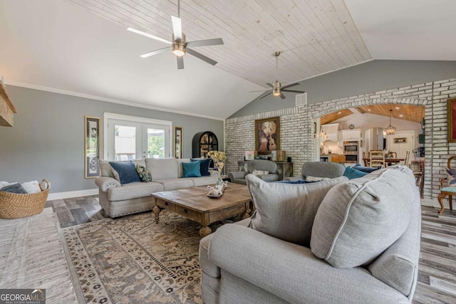 27 Graham Rd, Dallas, GA 30132 - living area with wood finished floors, vaulted ceiling, a ceiling fan, baseboards, and brick wall