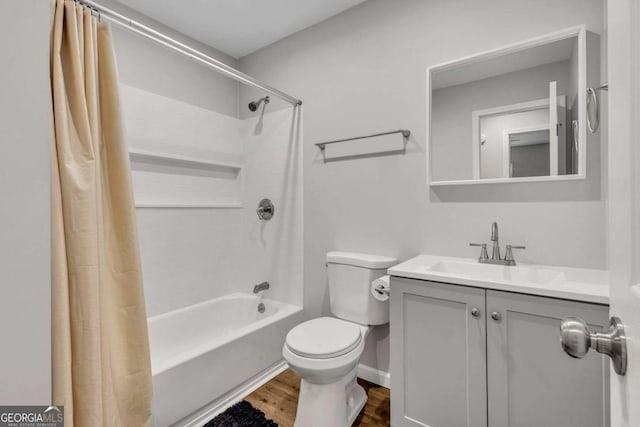 bathroom featuring wood finished floors, toilet, vanity, and shower / bathtub combination with curtain