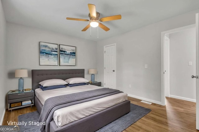 2184 Cherokee Valley Cir, Lithonia, GA 30058 - bedroom with wood finished floors and a ceiling fan