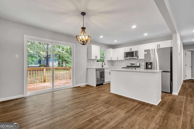 2184 Cherokee Valley Cir, Lithonia, GA 30058 - kitchen with stainless steel appliances, light countertops, a chandelier, white cabinetry, and dark wood finished floors