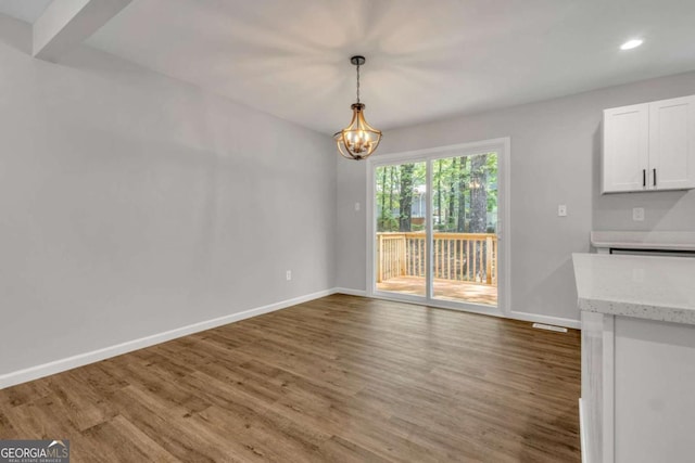 2184 Cherokee Valley Cir, Lithonia, GA 30058 - unfurnished dining area with a chandelier, wood finished floors, and recessed lighting