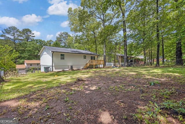 back of property featuring view of wooded area