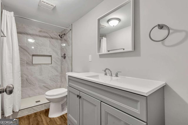 2184 Cherokee Valley Cir, Lithonia, GA 30058 - full bath with vanity, wood finished floors, and a tile shower