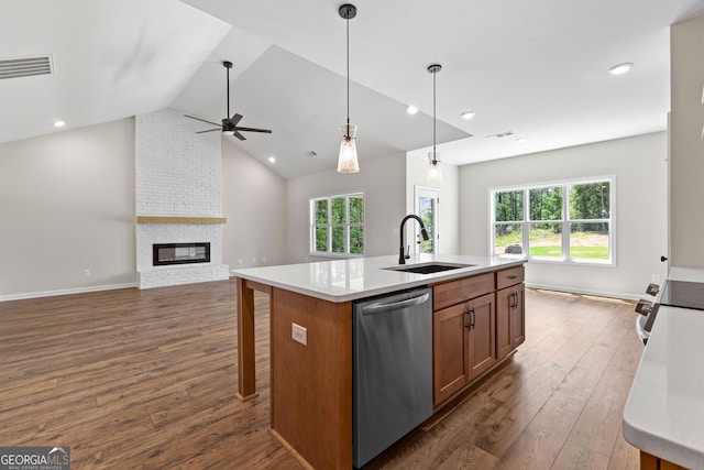 1356 Waymanville Rd, Thomaston, GA 30286 - kitchen featuring appliances with stainless steel finishes, a sink, brown cabinetry, dark wood-style flooring, and light countertops