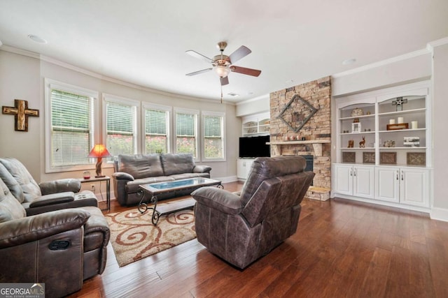 3230 Sundew Dr NW, Acworth, GA 30101 - living room with a ceiling fan, dark wood-style flooring, ornamental molding, a stone fireplace, and baseboards