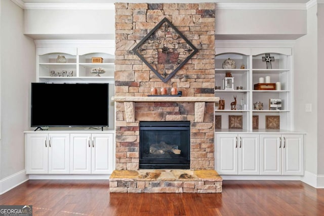3230 Sundew Dr NW, Acworth, GA 30101 - unfurnished living room with wood finished floors, crown molding, baseboards, and a fireplace