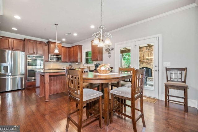 3230 Sundew Dr NW, Acworth, GA 30101 - dining room featuring crown molding, dark wood-type flooring, recessed lighting, a chandelier, and a fireplace