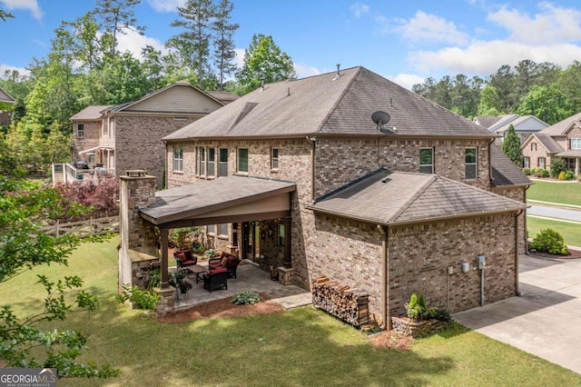 3230 Sundew Dr NW, Acworth, GA 30101 - back of property with a lawn, a patio, an outdoor hangout area, brick siding, and concrete driveway