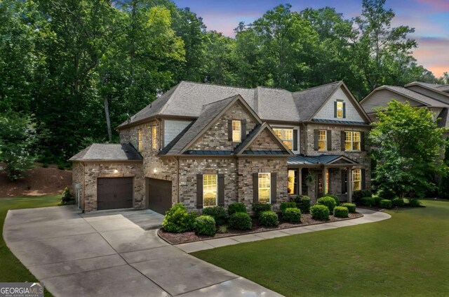3230 Sundew Dr NW, Acworth, GA 30101 - view of front of home with a garage, concrete driveway, a lawn, a standing seam roof, and a shingled roof