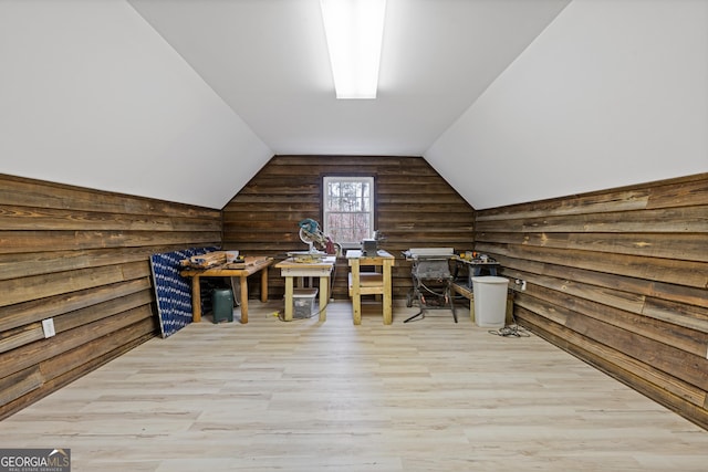 home office with wood finished floors, lofted ceiling, and rustic walls